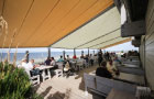 Image of pergolas fitted over seating area of a North Sea cafe.